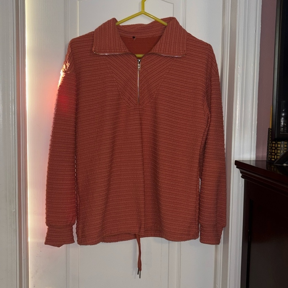 BURNT ORANGE TOP WITH DRAW STRING ON BOTTOM HEM LONG SLEEVES TEXTURED MATERIAL